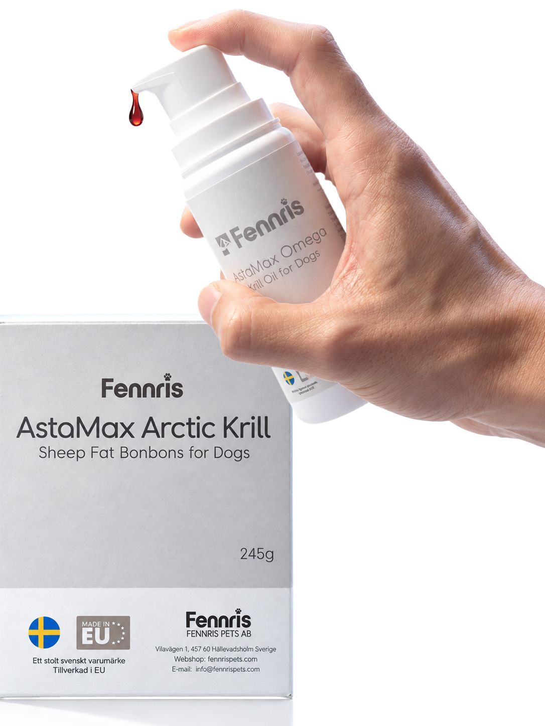 Hand holding Fennris Pets AstaMax Arctic Krill bottle with a droplet above the box packaging
