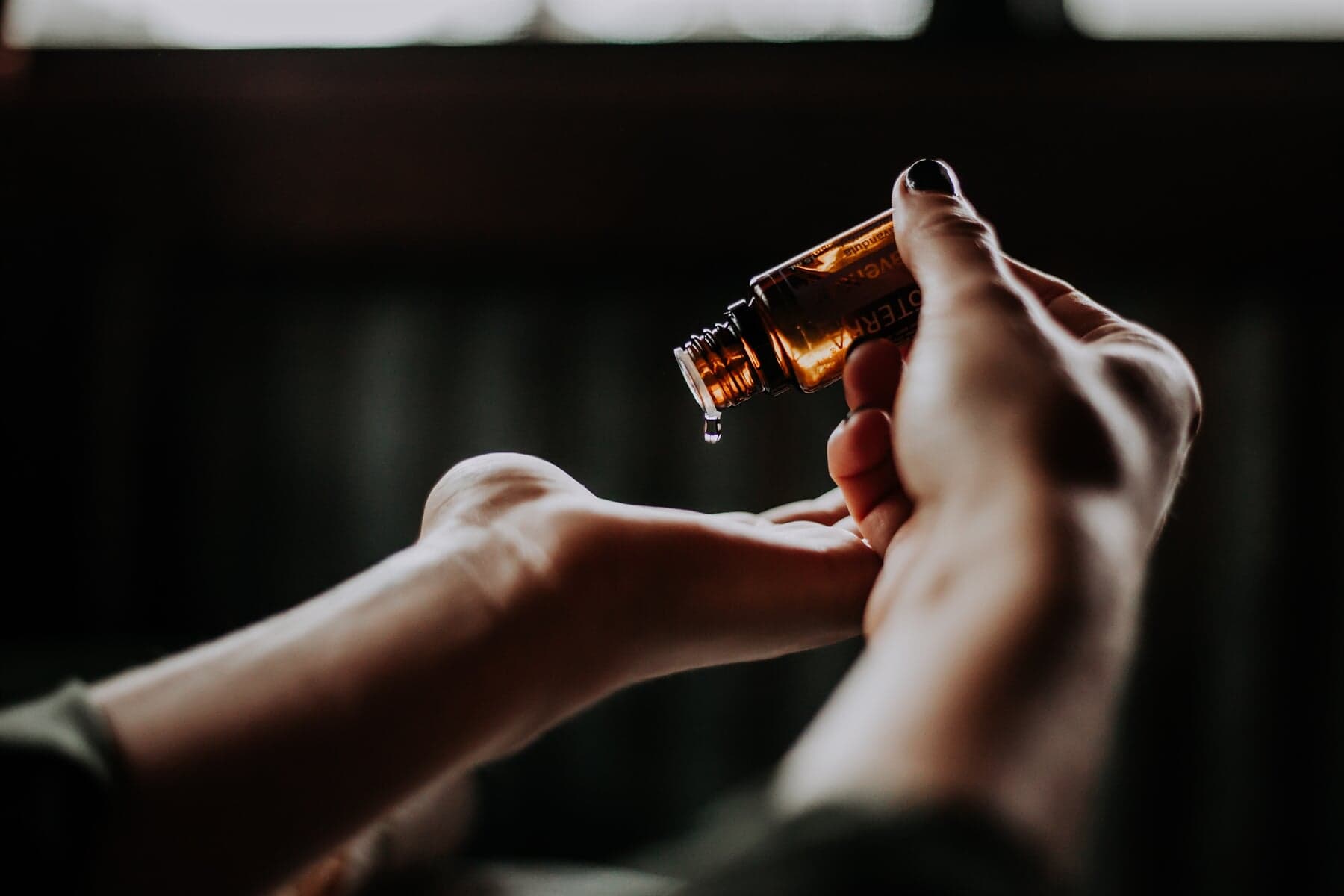 Person Pouring Essential Oil Onto Hands — Naturopath in Toowoomba, QLD