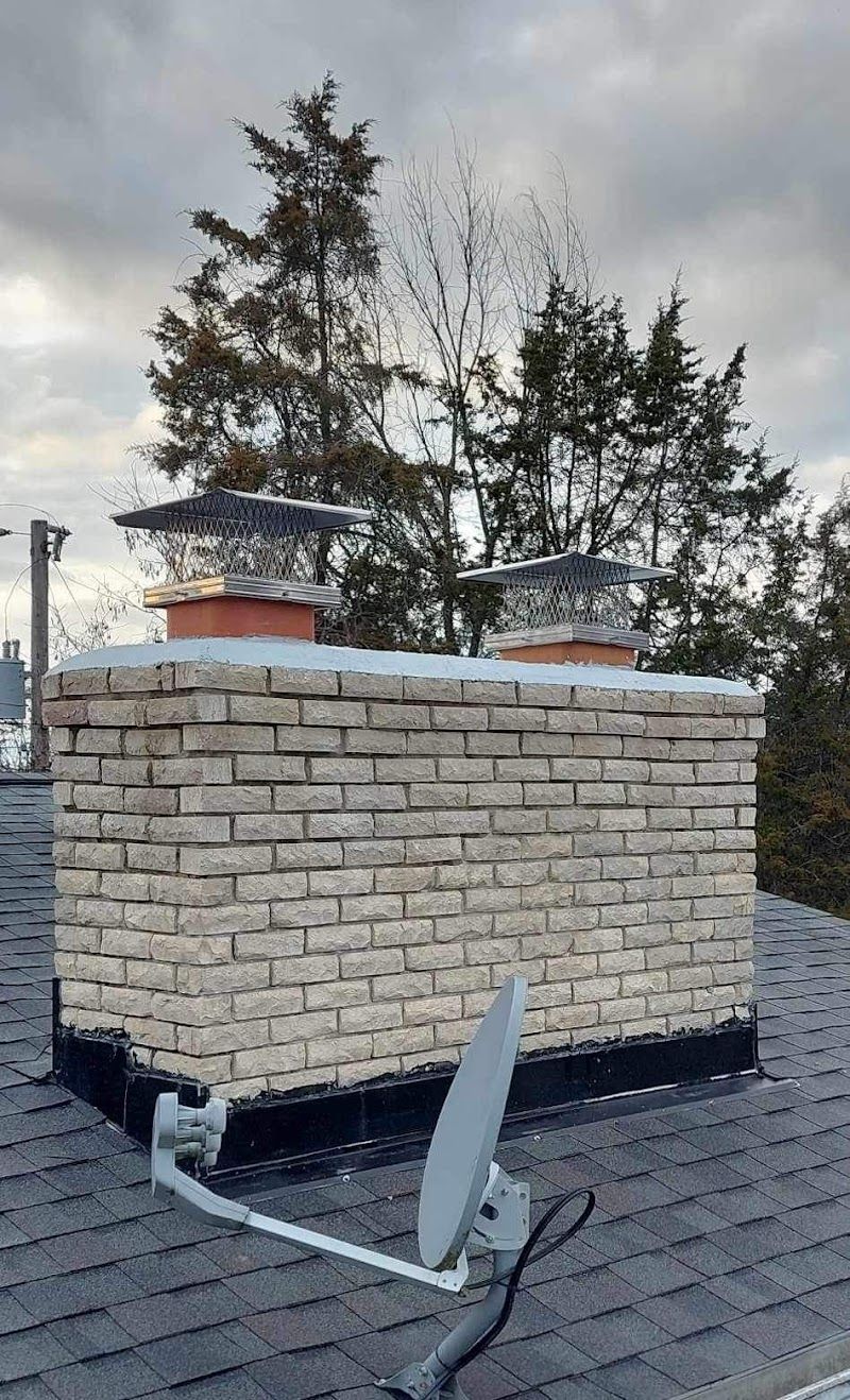 A chimney on top of a roof with a satellite dish attached to it.
