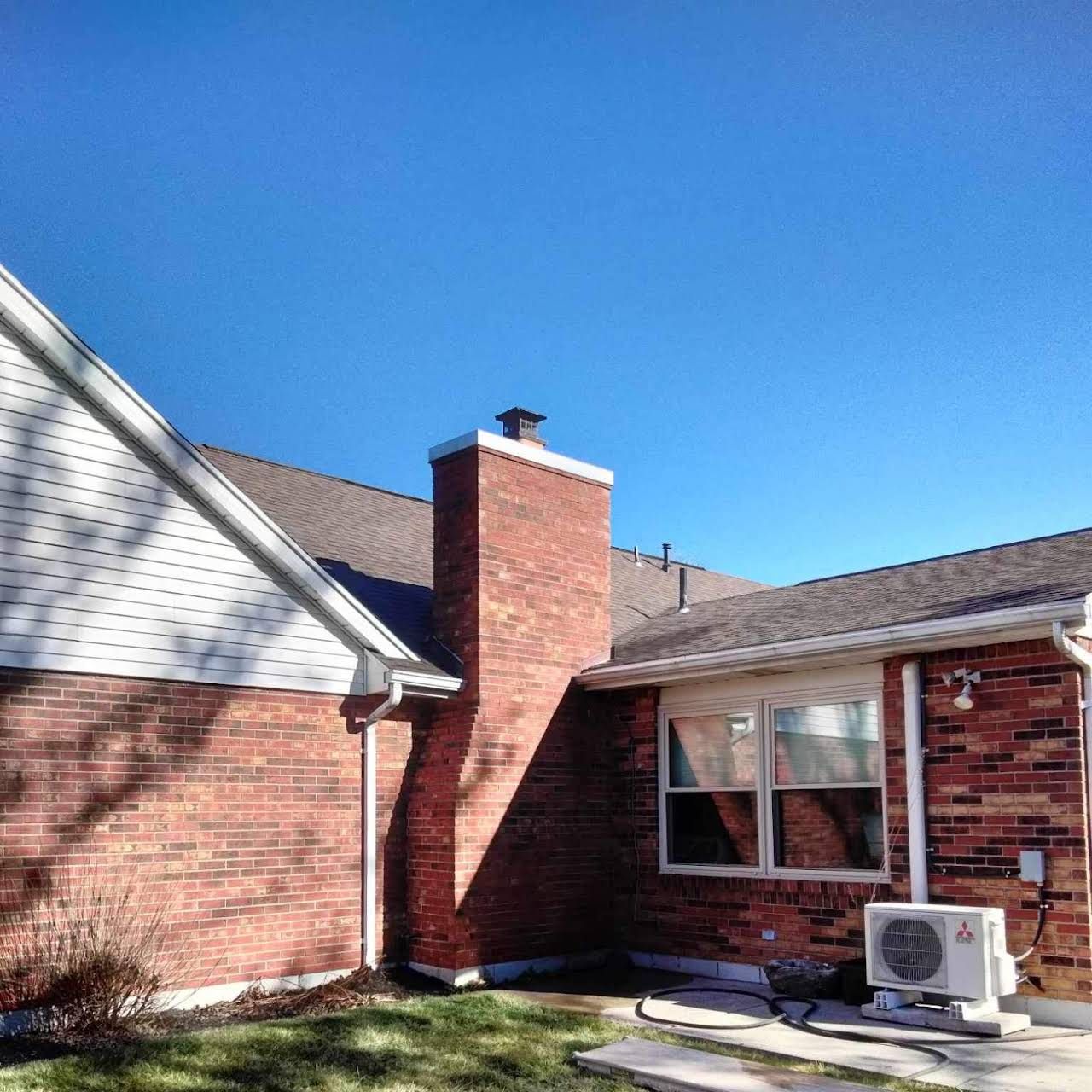 A brick house with a chimney on the side of it