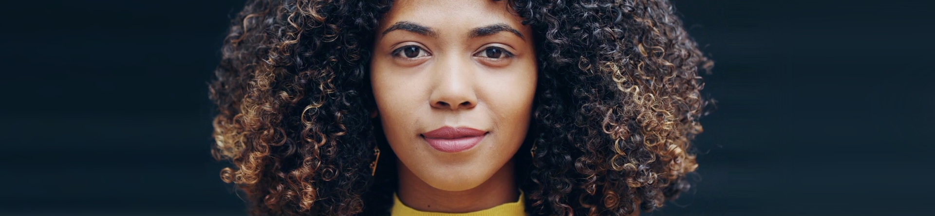beautiful young biracial woman with natural hair and smooth skin