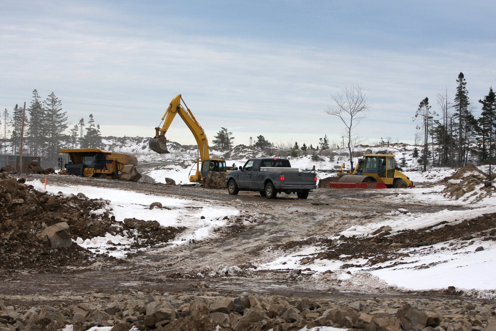A truck is parked in the middle of a construction site.