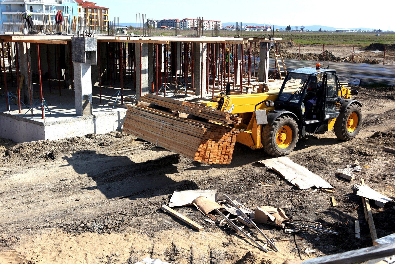 A yellow bulldozer is at a construction site
