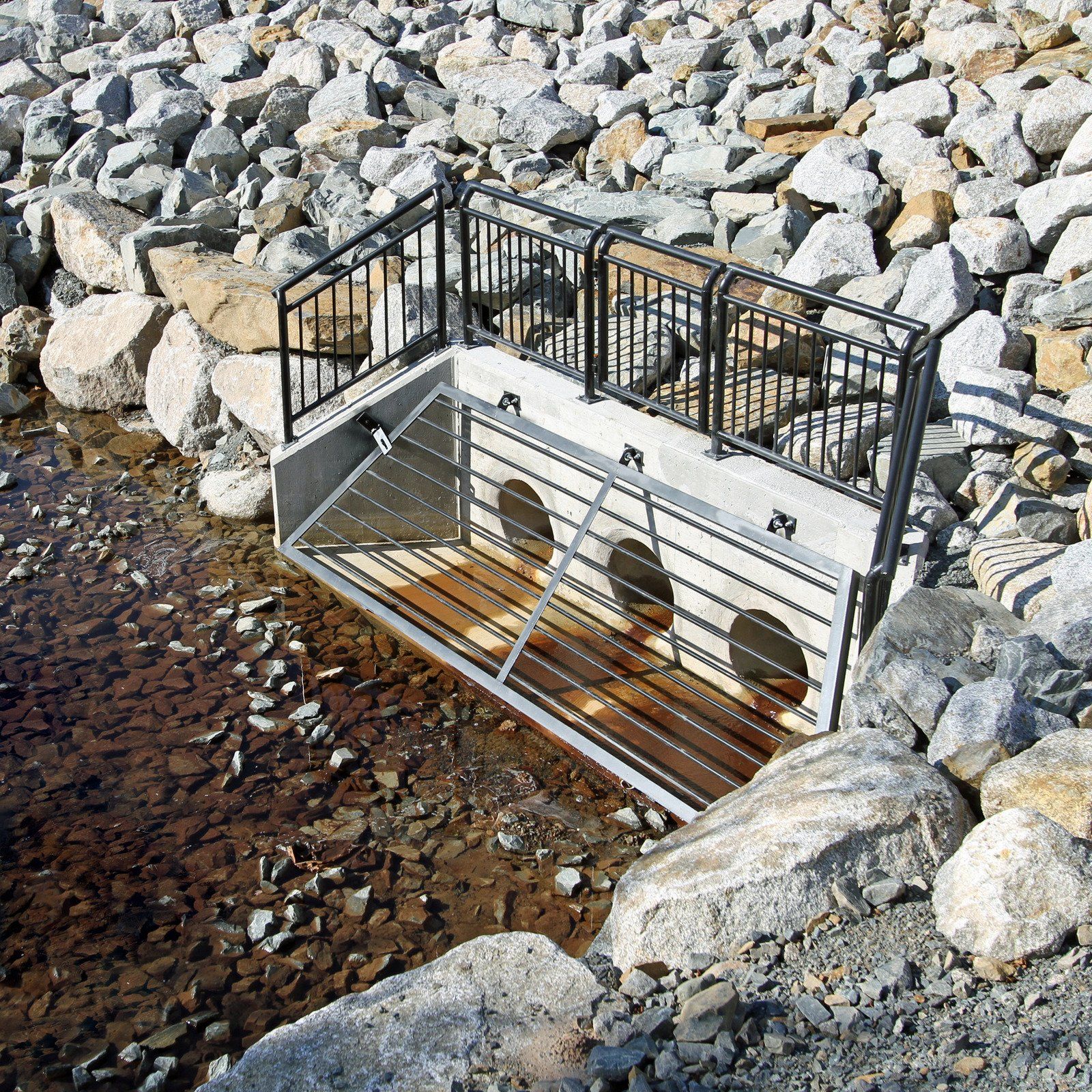 A bridge over a river surrounded by rocks and water