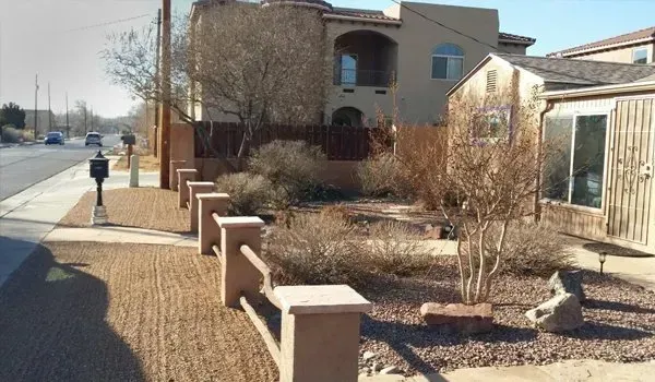 A house with a fence and a mailbox in front of it