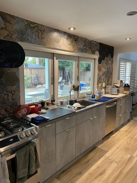 A kitchen with a stove , sink , and dishwasher