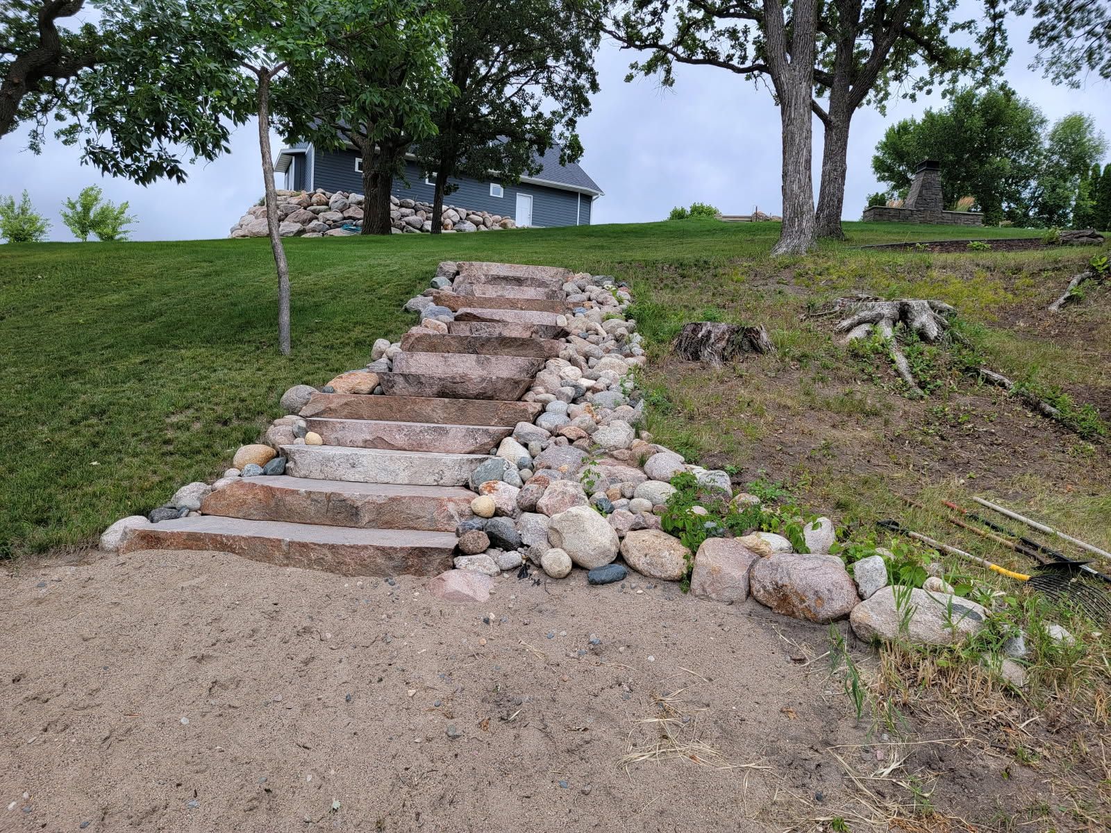 A stone walkway leading to a house on a hill