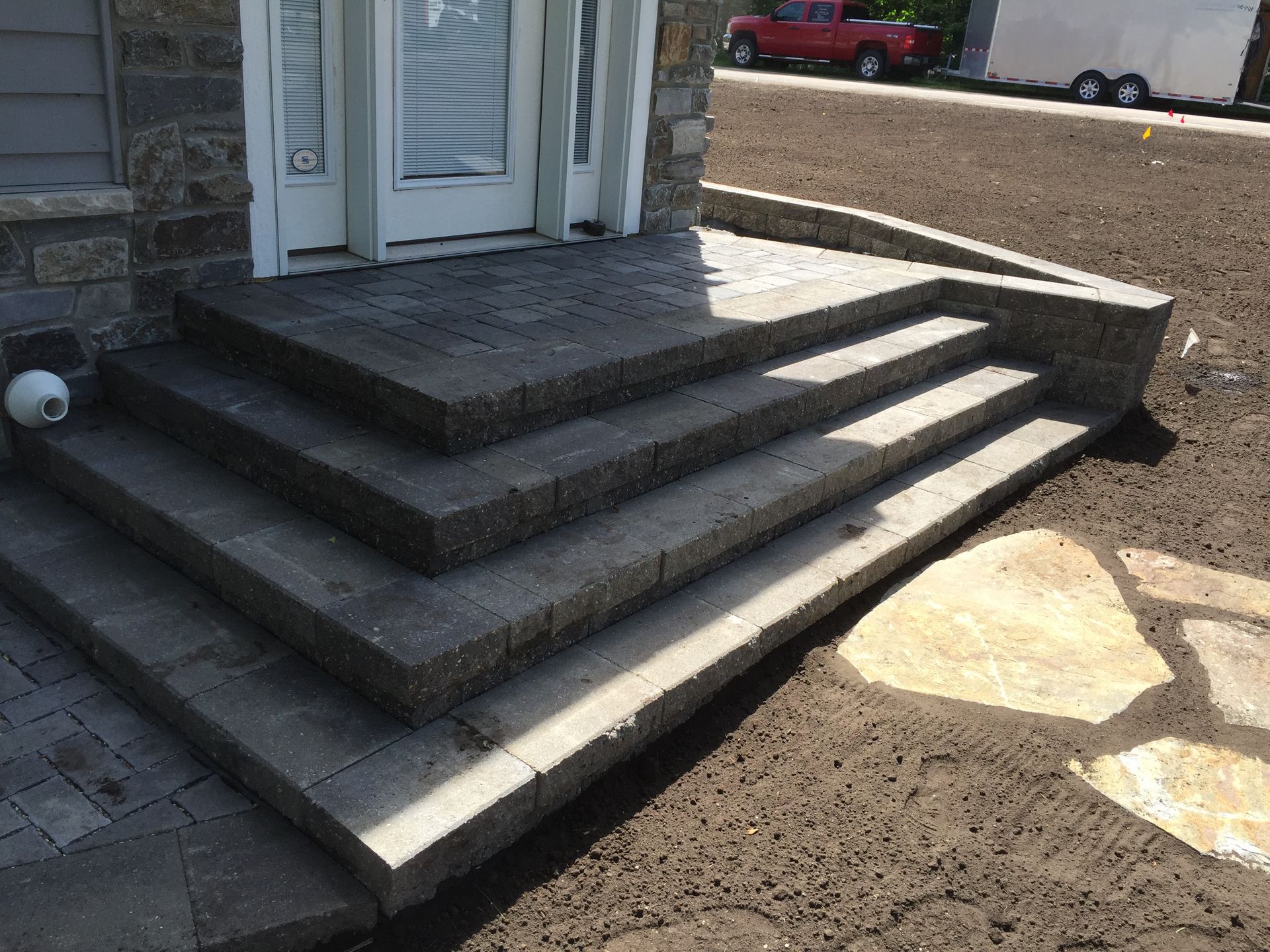 A set of stairs leading up to the front door of a house.