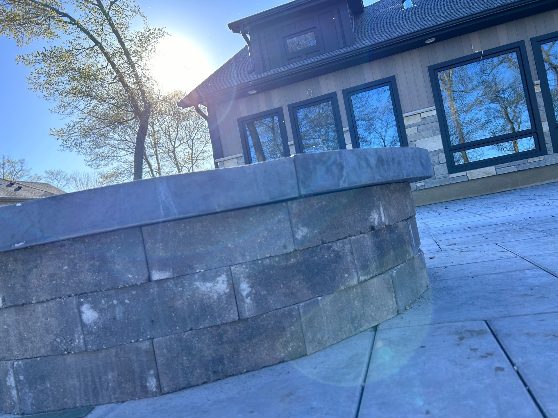 A fire pit is sitting in front of a house.
