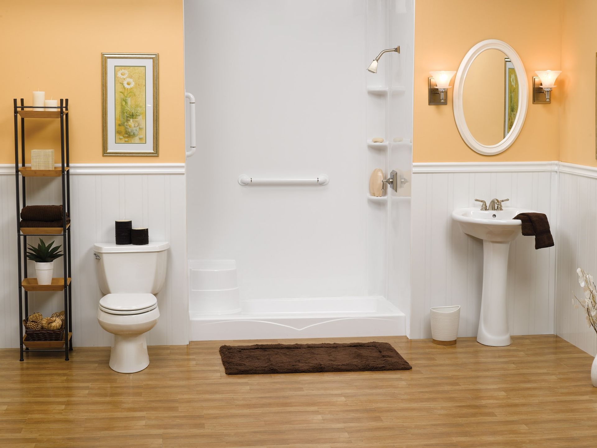 Bathroom with toilet, sink, shower, mirror, and tan walls over wood flooring.