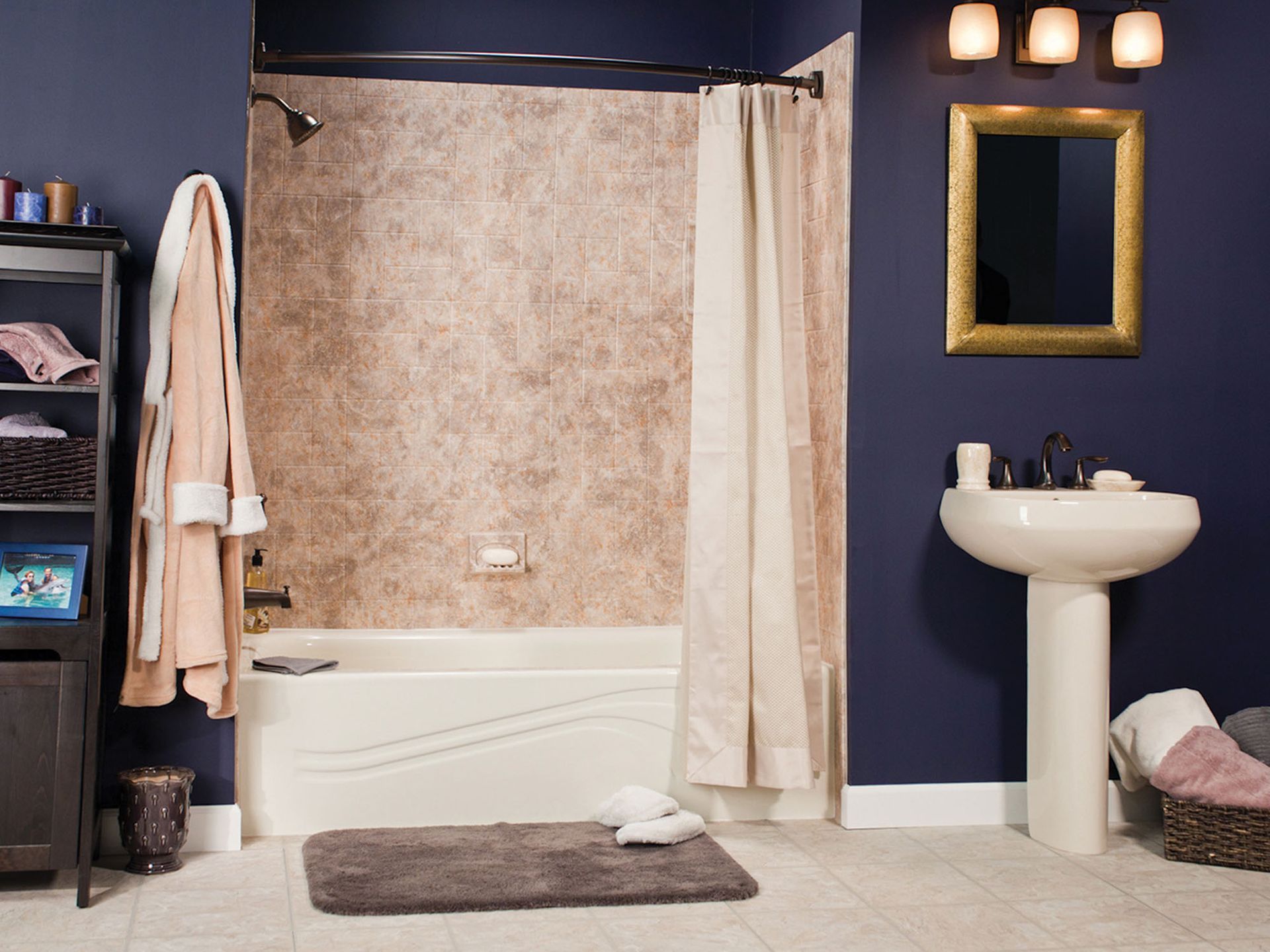 Bathroom with blue walls, white sink, shower curtain, mirror, and towels on a rack