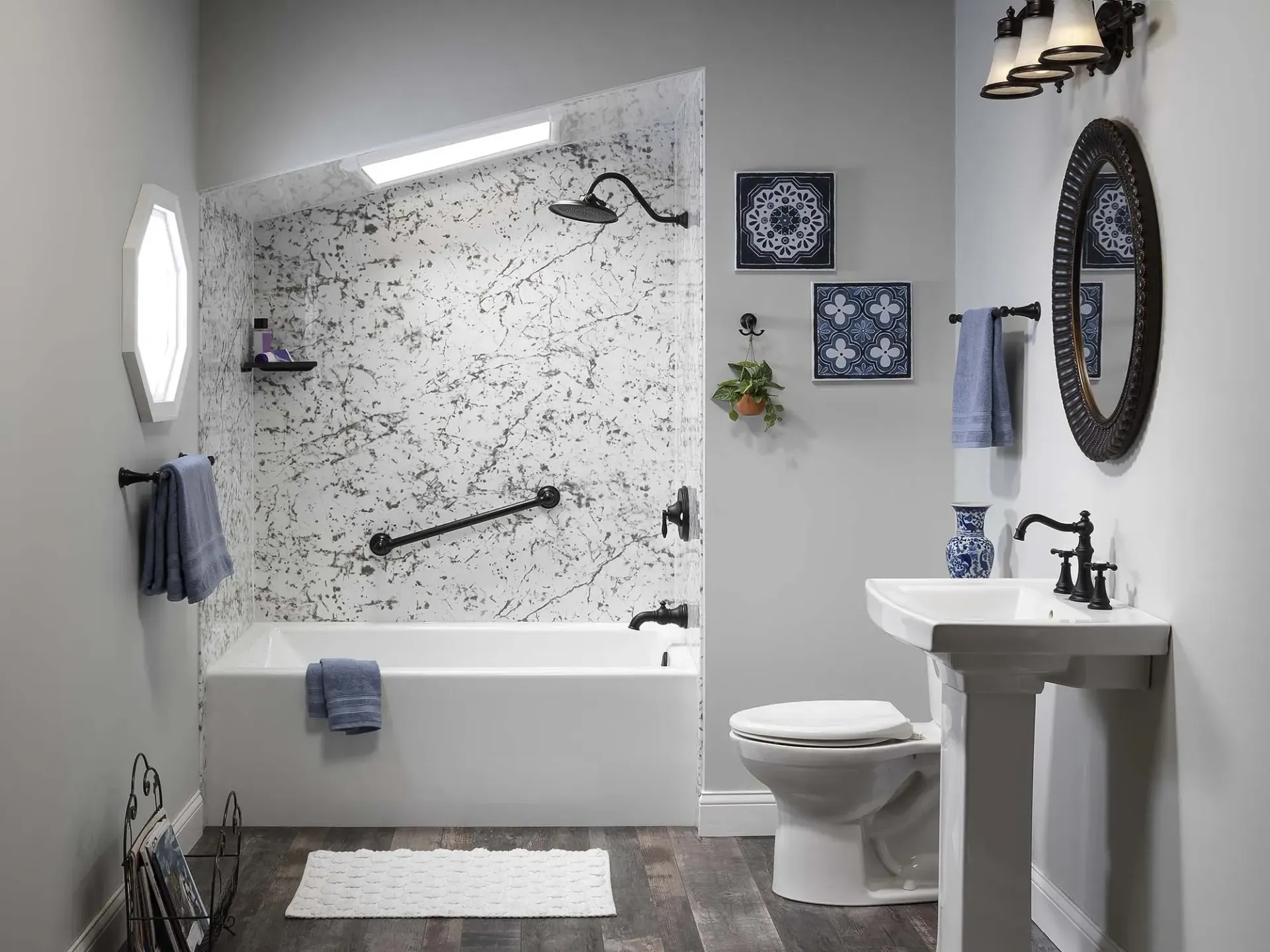 Modern bathroom with tub, shower, sink, toilet, and gray-and-white decor