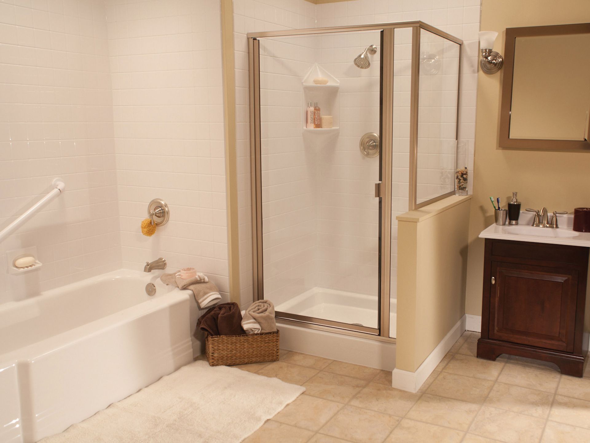 Bathroom with a walk-in shower, bathtub, wicker basket, and vanity sink with mirror.
