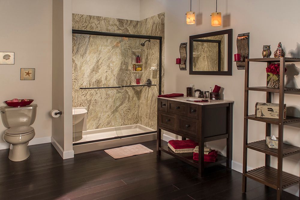 Modern bathroom with walk-in shower, dark vanity, toilet, and shelving on the right.