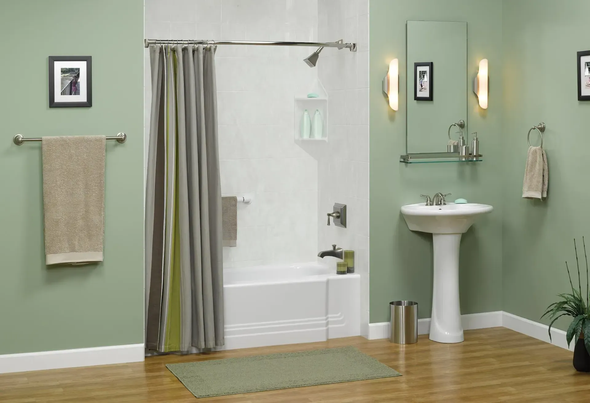 Accessible bathroom with shower, pedestal sink, towels, mirror, and green walls