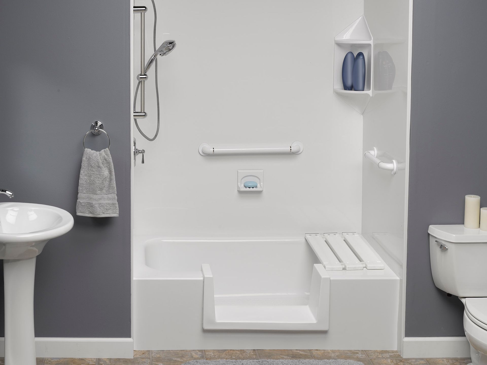 Accessible white bathroom with walk-in shower, grab bars, and toilet seating area