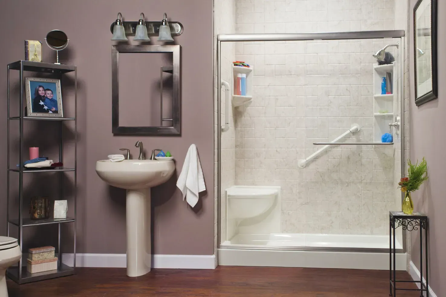 Modern bathroom with pedestal sink, shower, and shelving in gray and white tones