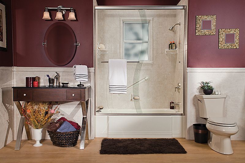 Stylish bathroom with shower, vanity, toilet, and burgundy walls.