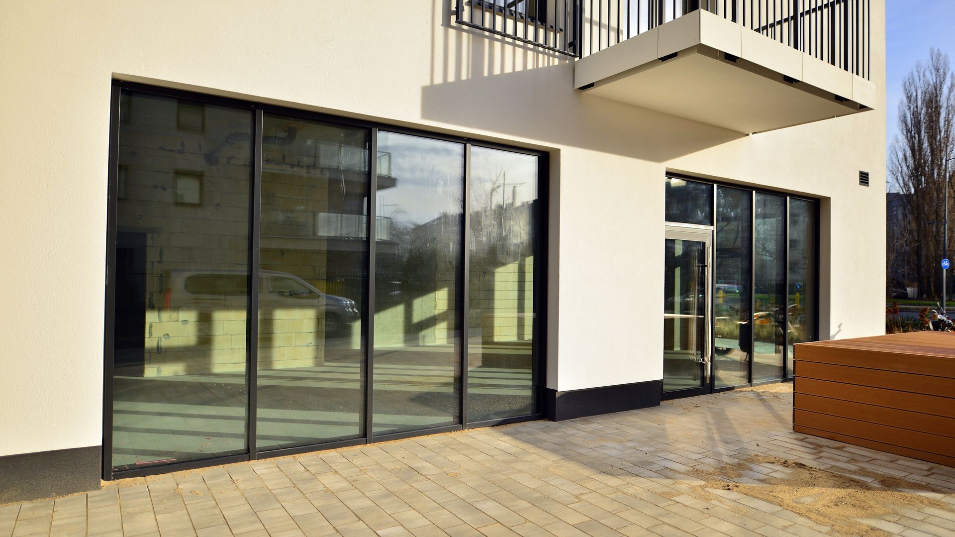 Modern building exterior with large glass windows and entrance.