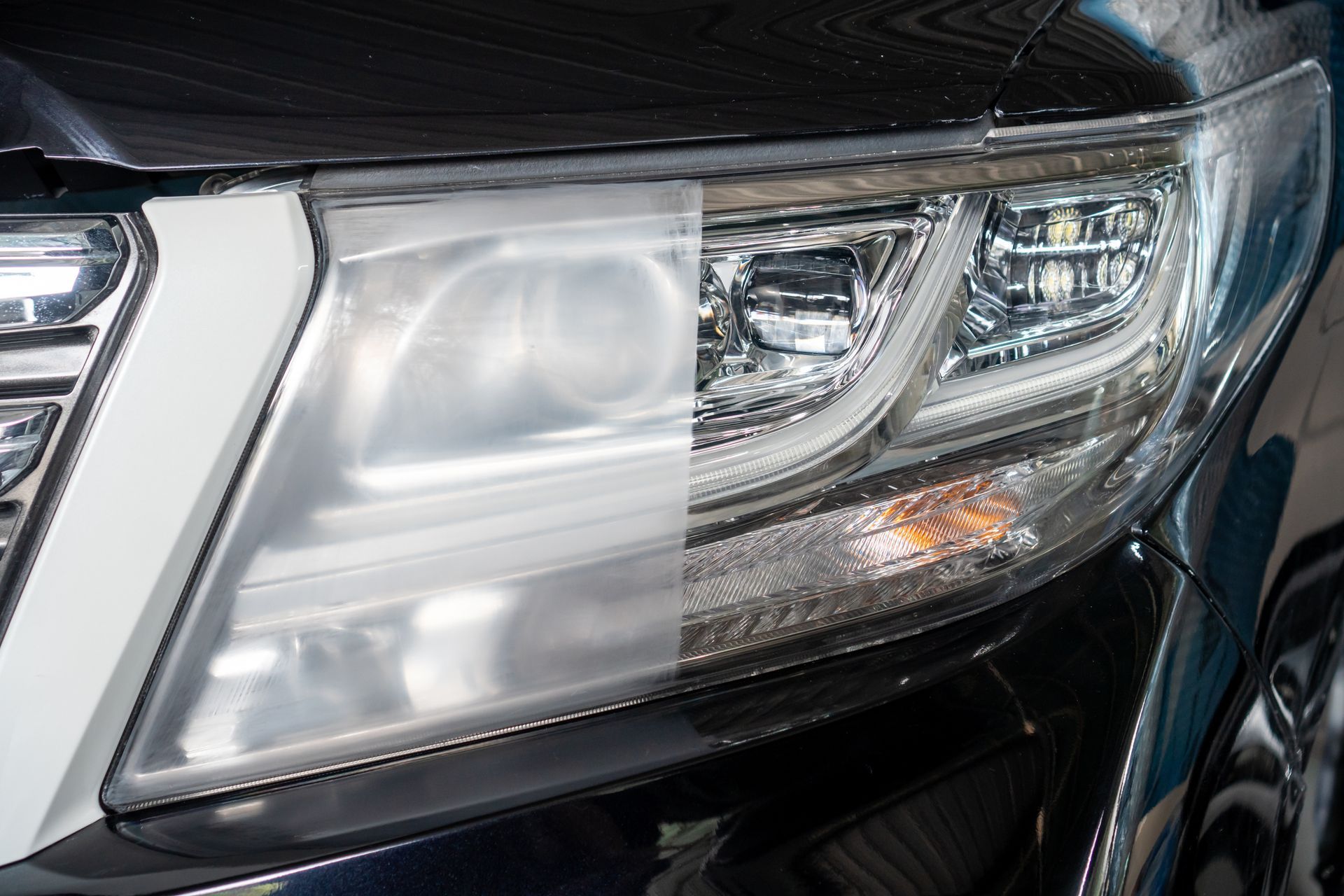 Car headlight, half clouded and half clear, showing before and after restoration.