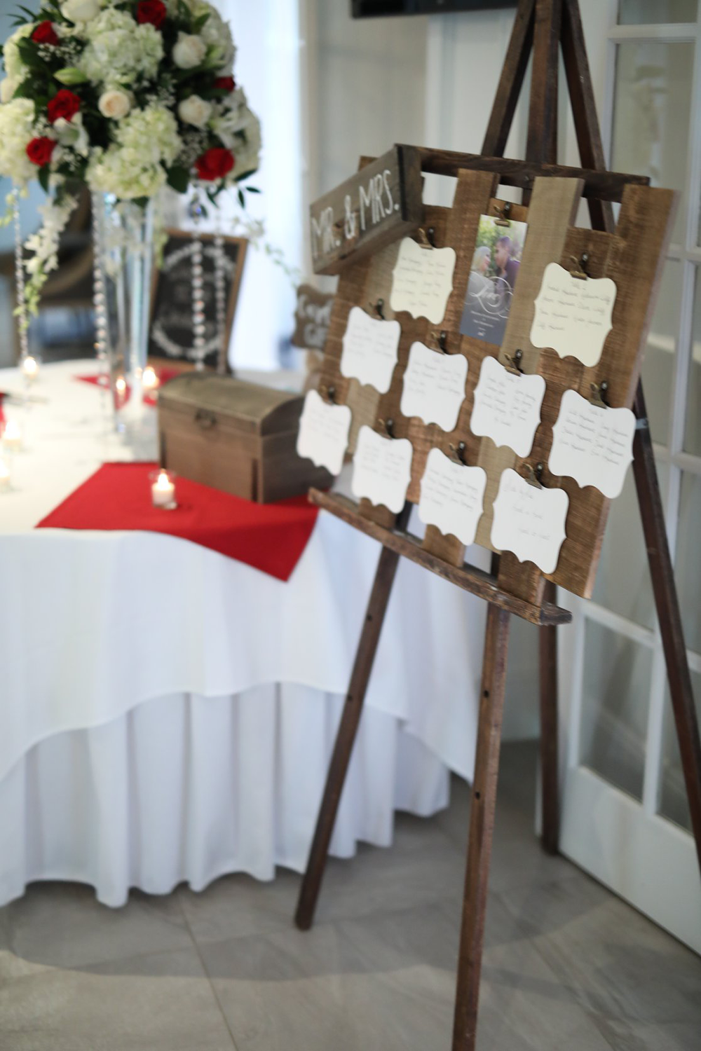 A wooden easel with a seating chart on it