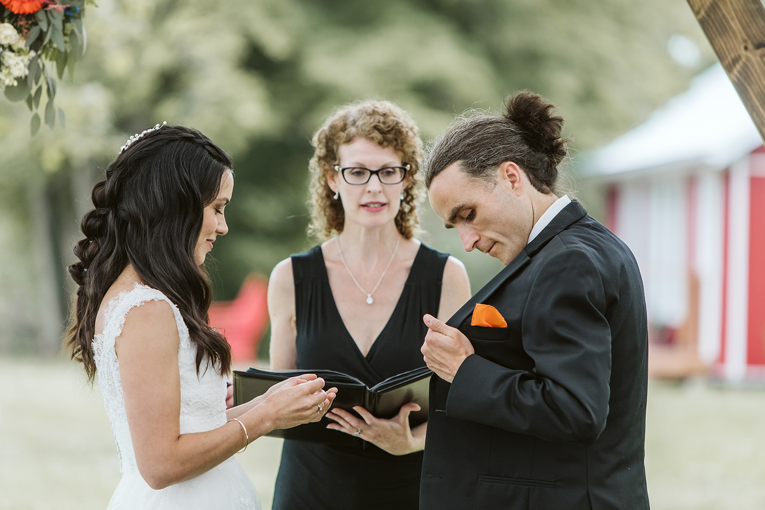 A bride and groom are getting married at a wedding ceremony.