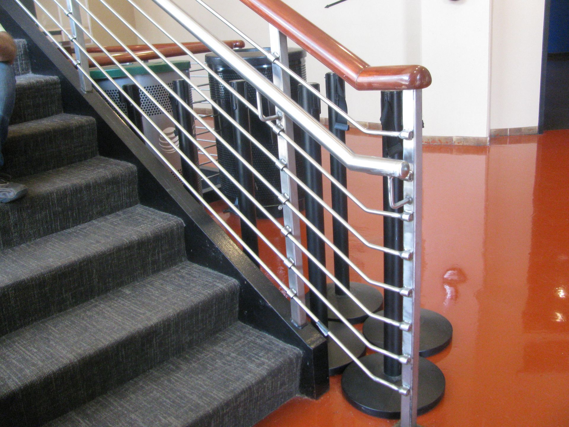 A Person Walking Down a Set of Stairs with a Metal Railing | San Antonio, TX | Texas Sheet Metal