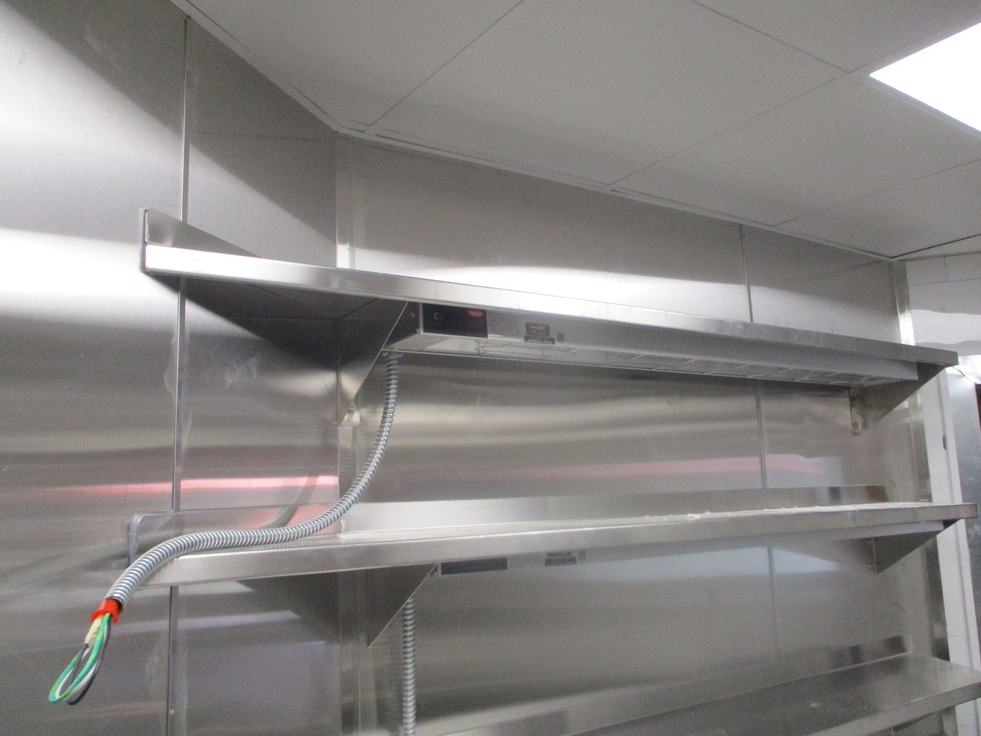 A Stainless Steel Shelf is Hanging from the Ceiling in a kitchen | San Antonio, TX | Texas Sheet Metal
