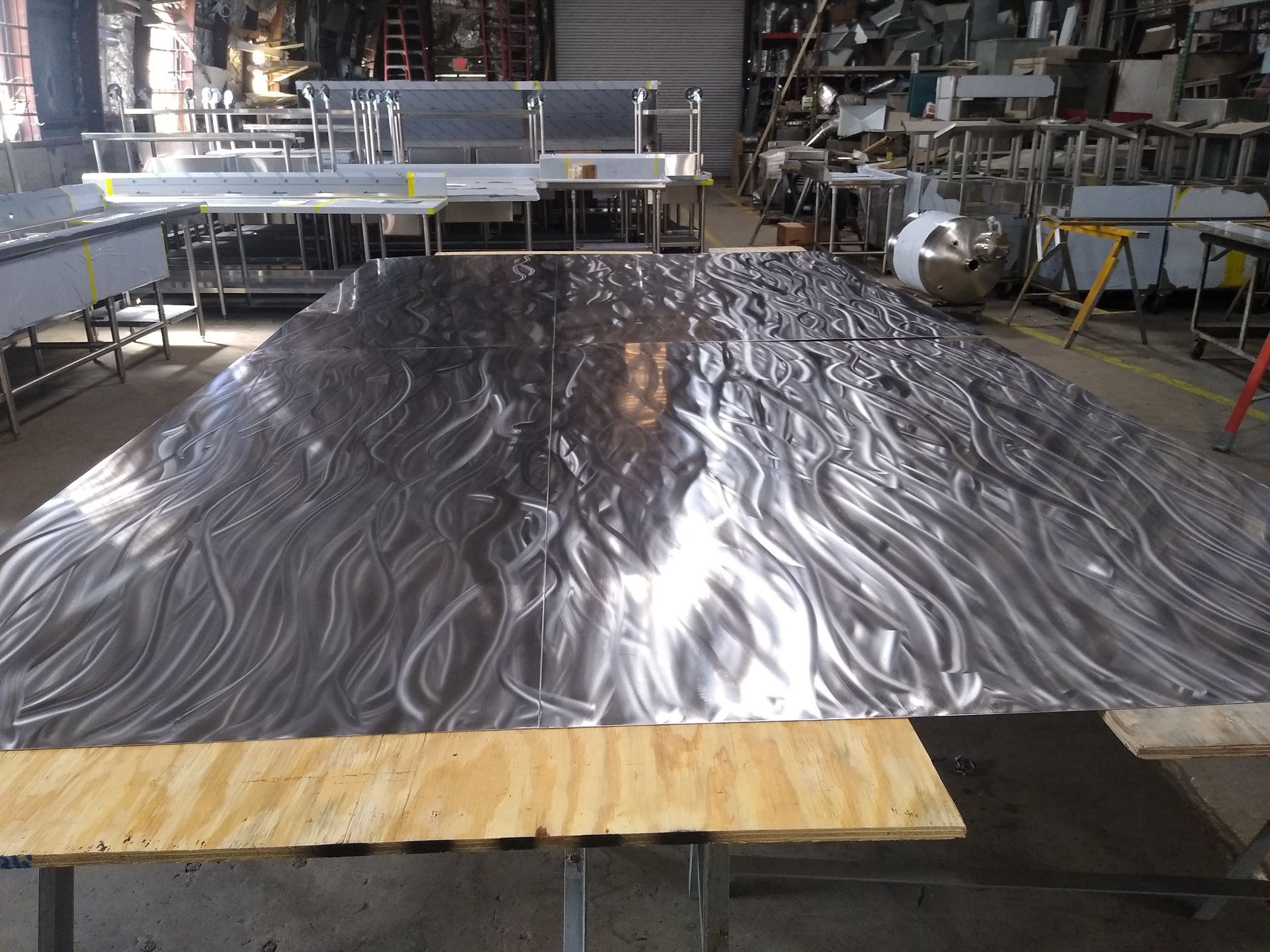 A Large Piece of Metal is Sitting on Top of a Wooden Table in a Factory | San Antonio, TX | Texas Sheet Metal