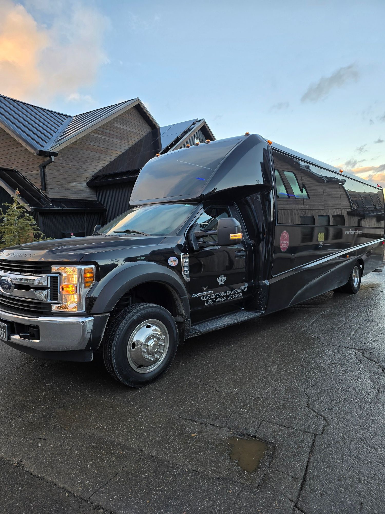 A black truck is parked in front of a house.