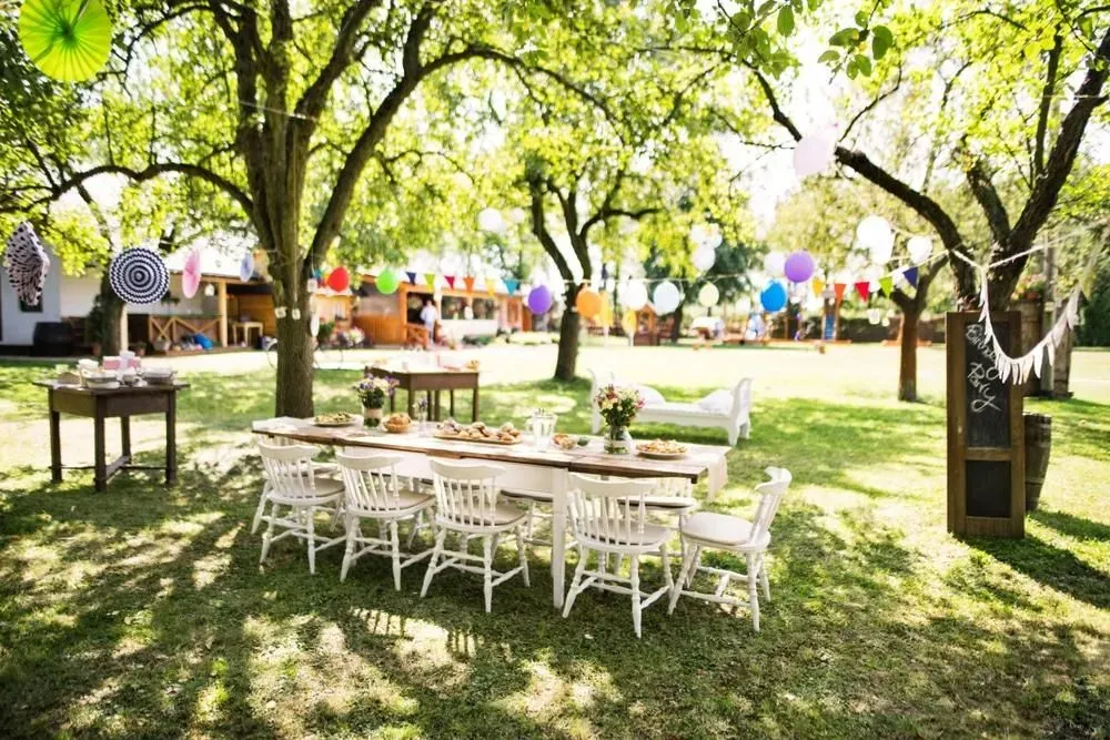 A Table and Chairs are Set up in The Grass For a Party — Event Hire in Wodonga, NSW