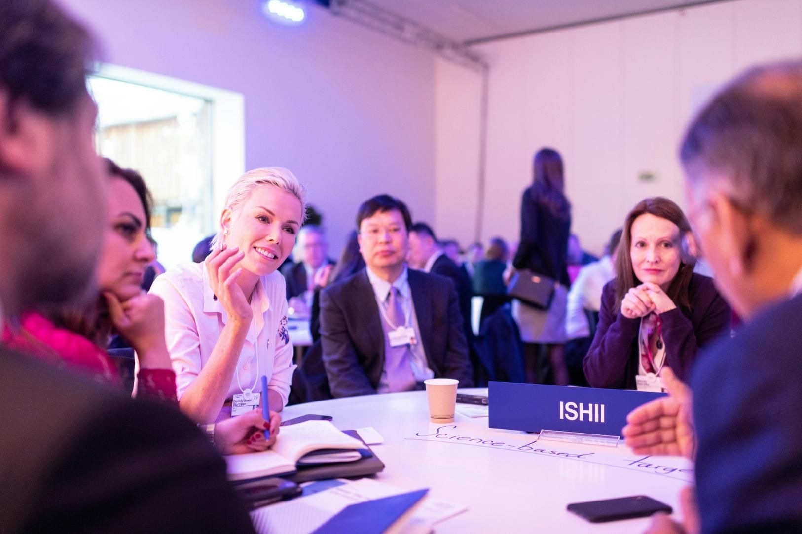 A Group of People are Sitting Around a Table Having a Meeting — Event Hire in Wodonga, NSW
