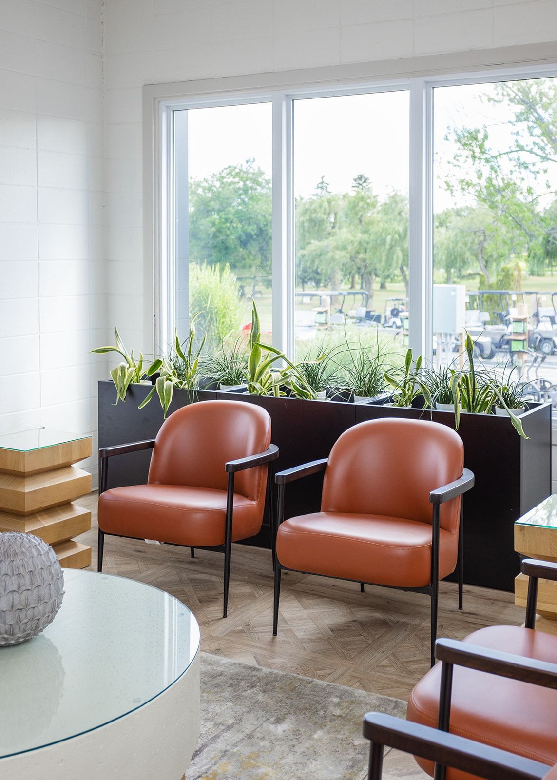 Brock Golf Clubhouse café dining area featuring cozy plaid upholstered booths and a warm, welcoming atmosphere for guests.