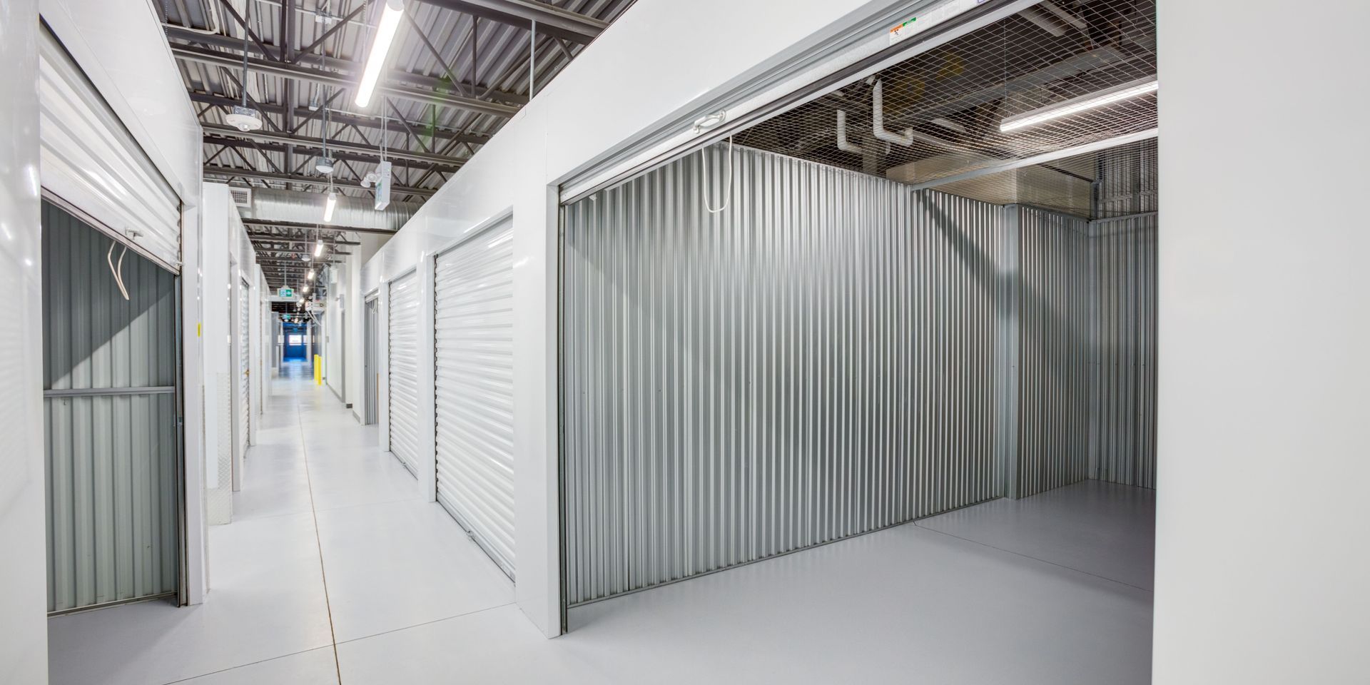 A long hallway filled with lots of empty storage units.