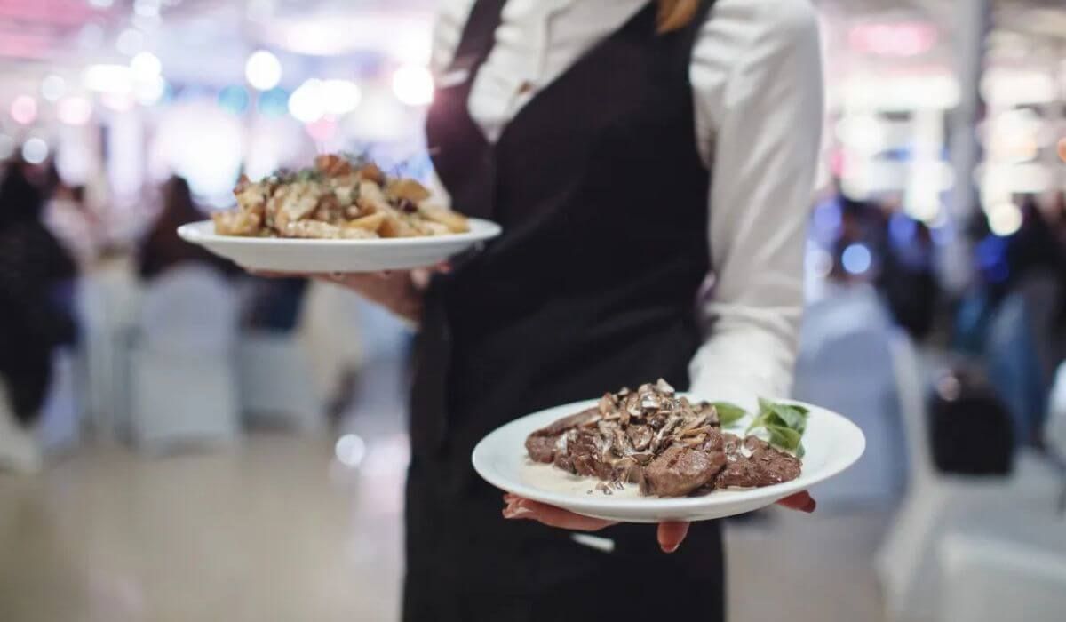 catering staff preparing food table event