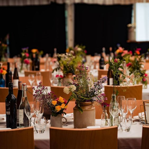 Wedding reception dining table with elegant catering setup Elegant wedding dining table with plated meals, floral centrepieces, and catering presentation