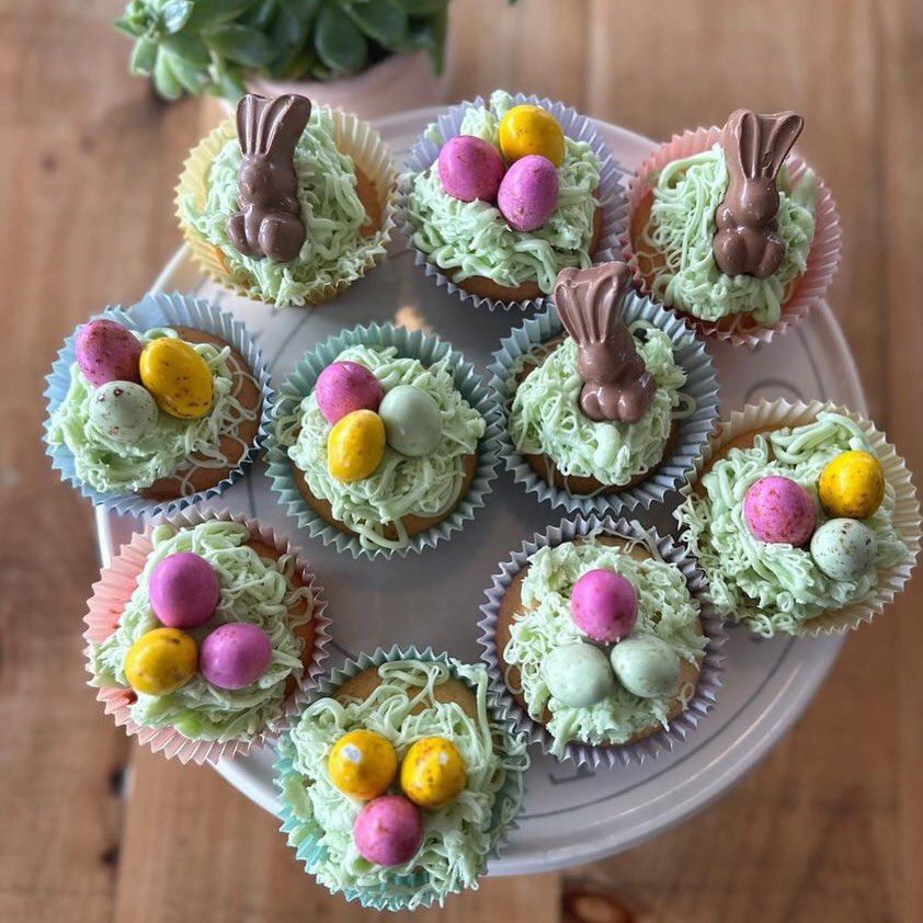 a white plate topped with cupcakes decorated for easter