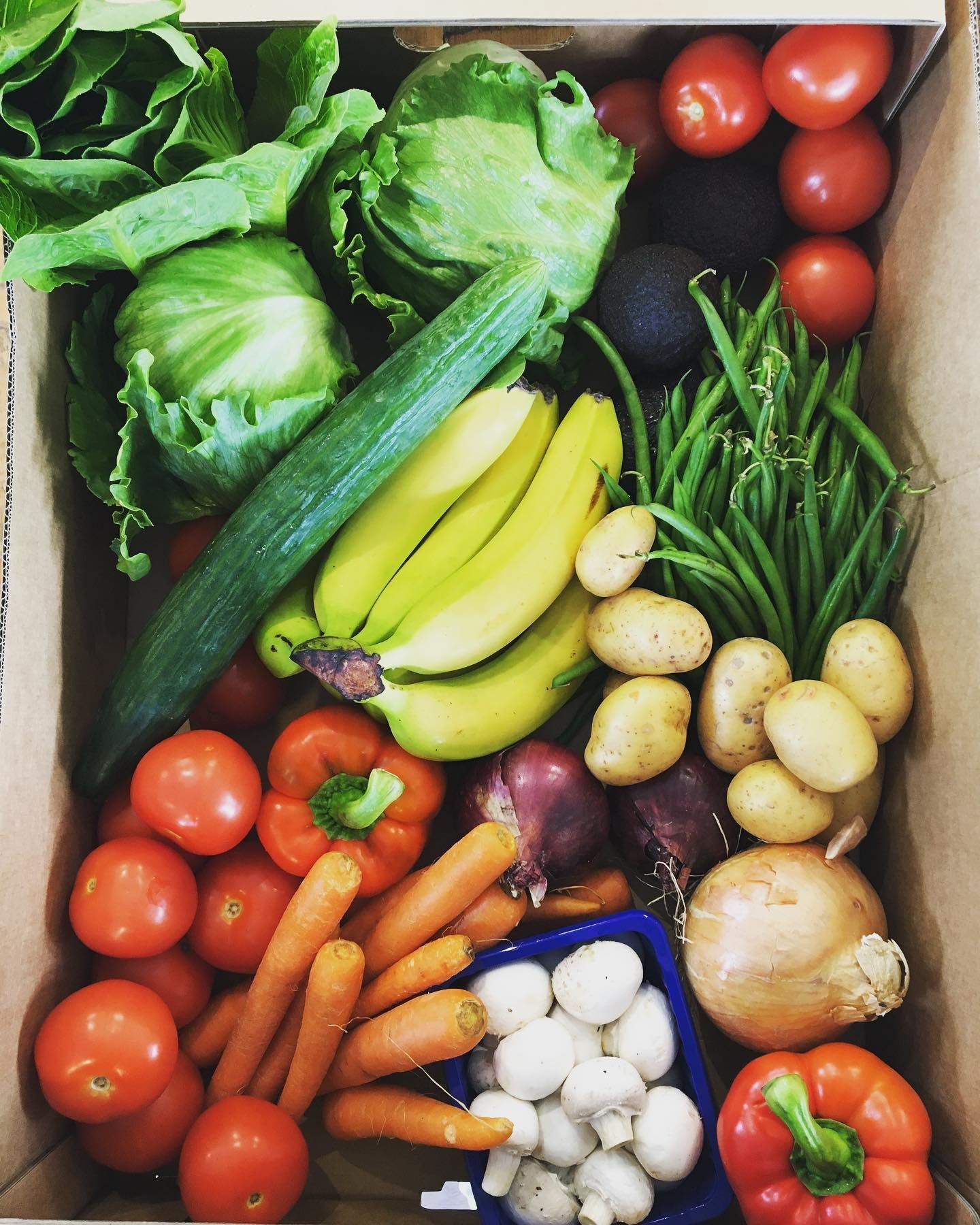 a box filled with lots of fruits and vegetables