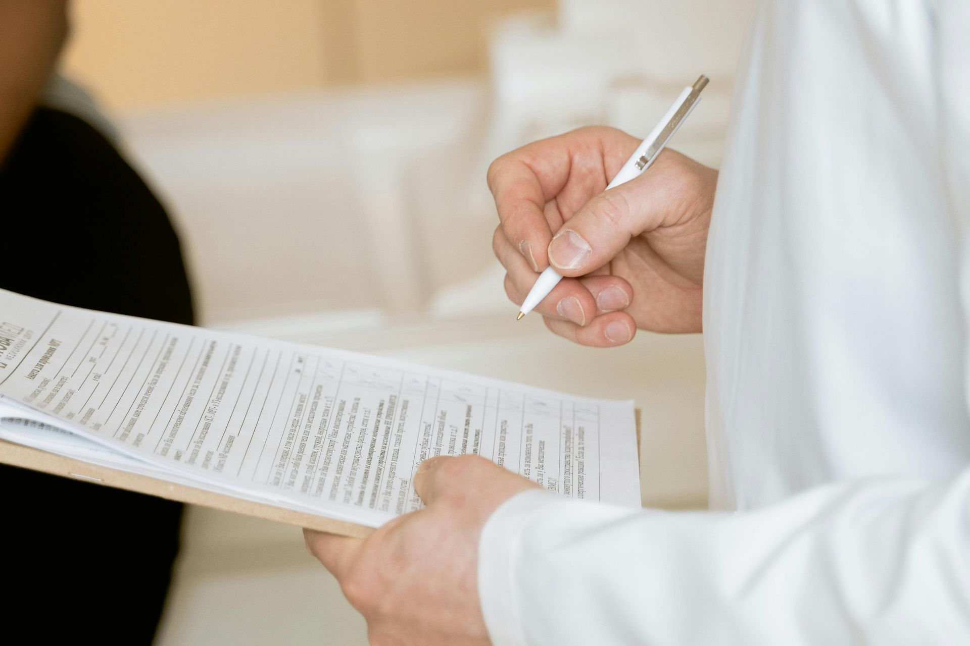 Doctor is documenting a patient chart with a pen
