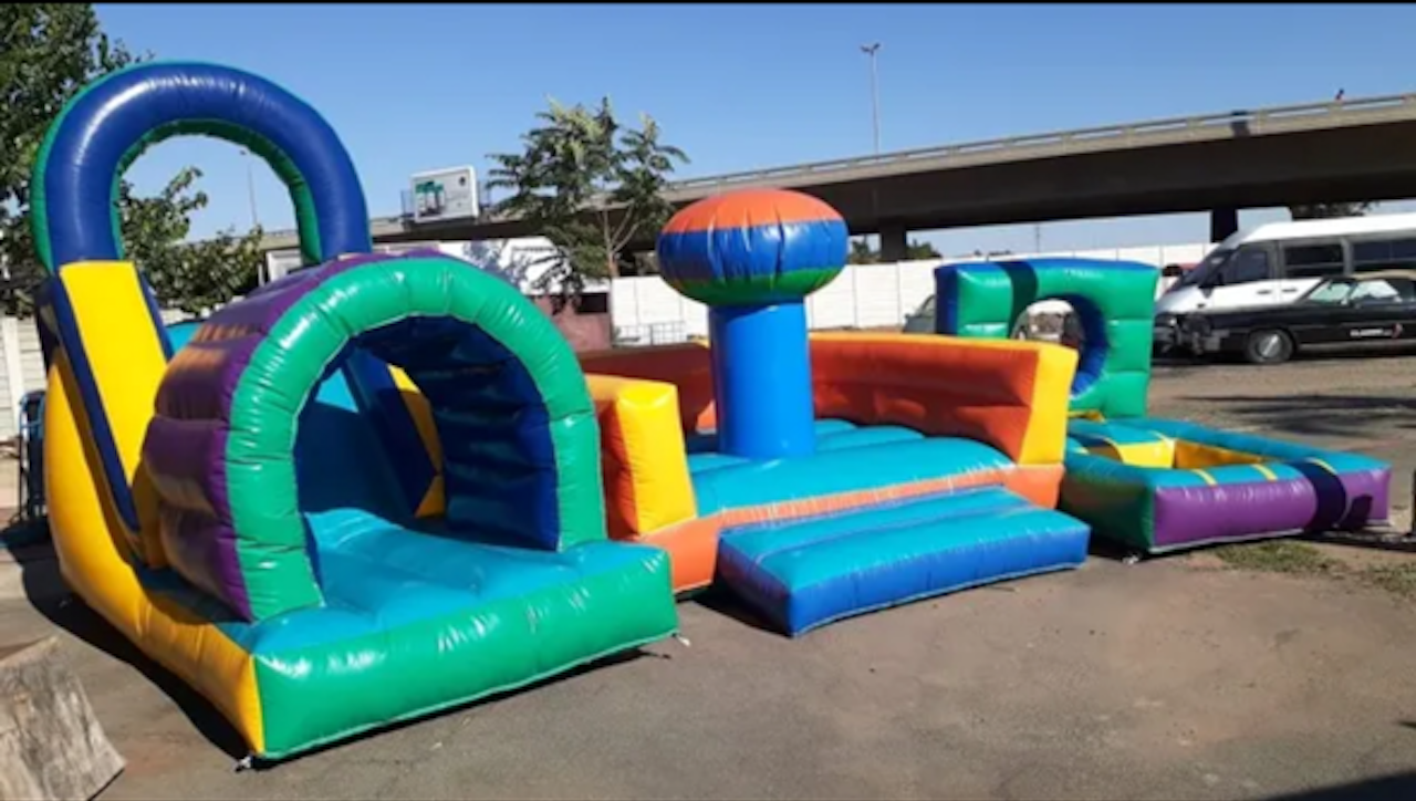 A colorful bouncy house is sitting in a parking lot.