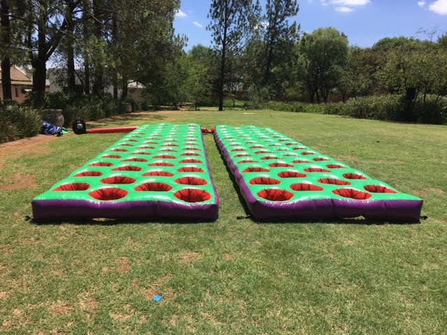 Two inflatable boards are sitting on top of a lush green field.