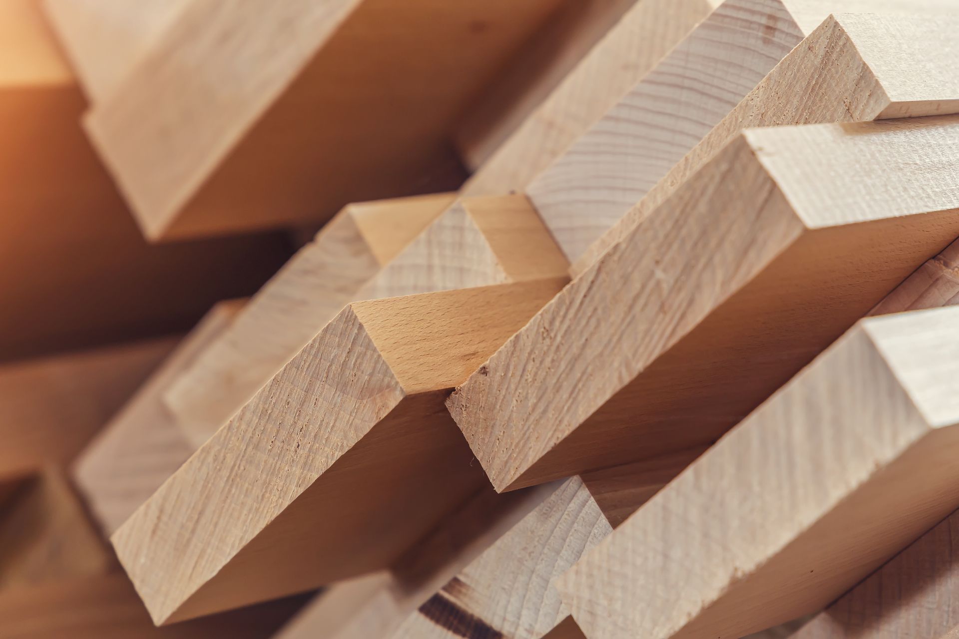 A close-up of a stack of wooden bars as construction material.