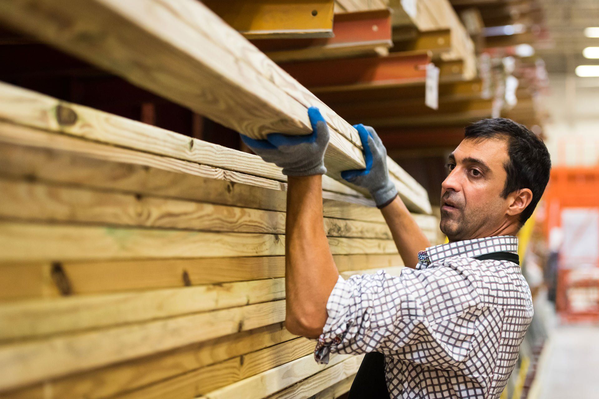 Man Lifting a Wood with Gloves on Their Hand | Brisbane, Qld | Virginia Building Supplies Man Lifting a Wood with Gloves on Their Hand | Brisbane, Qld | Virginia Building Supplies