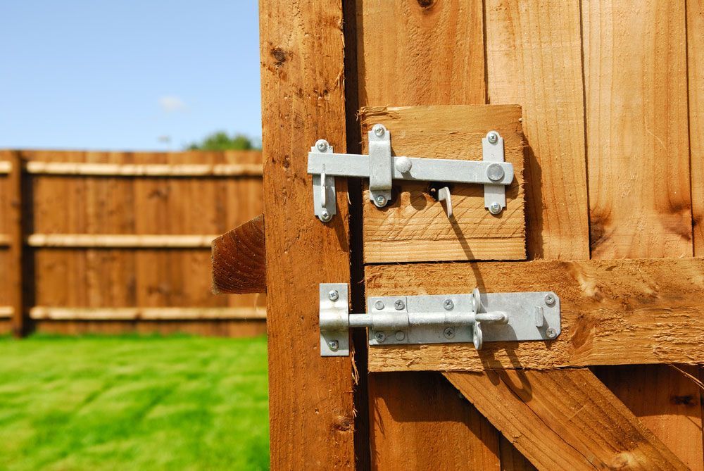 A wooden fence with a metal latch on it — Locksmith in Tweed Heads, NSW