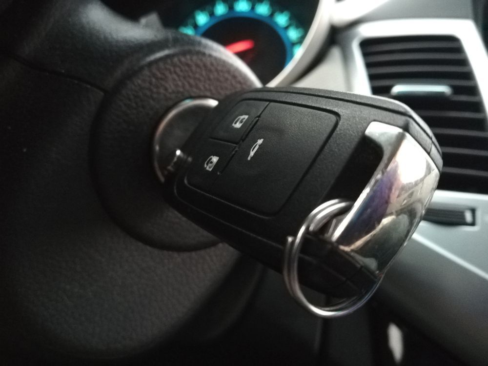 A car key is sitting on the steering wheel of a car — Locksmith in Tweed Heads, NSW