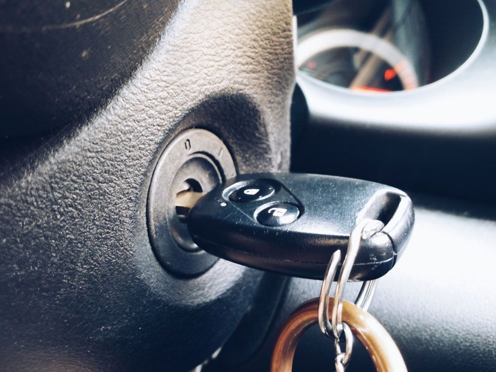 A car key is plugged into the ignition of a car — Locksmith in Helensvale, QLD