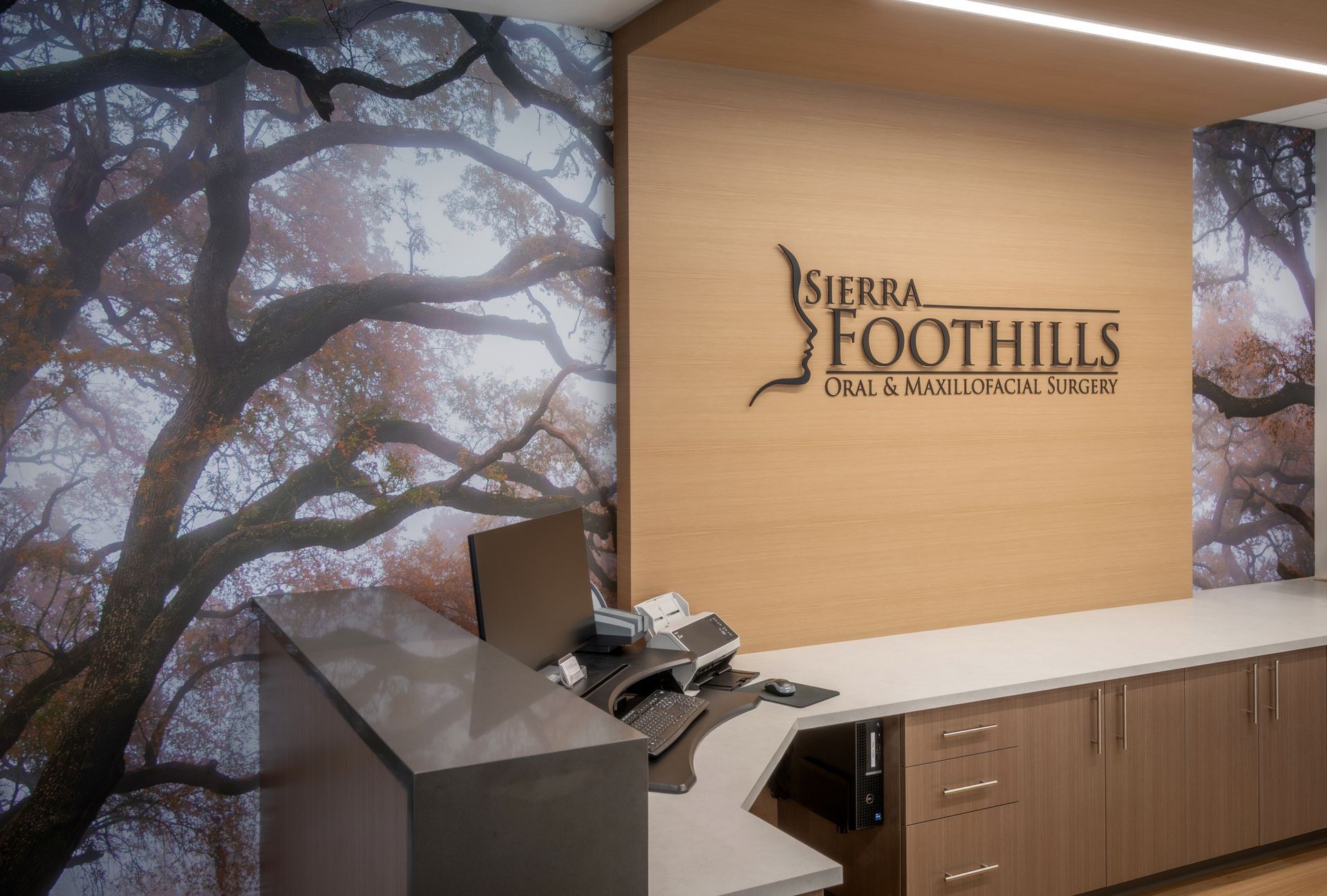 Office interior with the Sierra Foothills Eye Care Center logo on a wooden wall. 