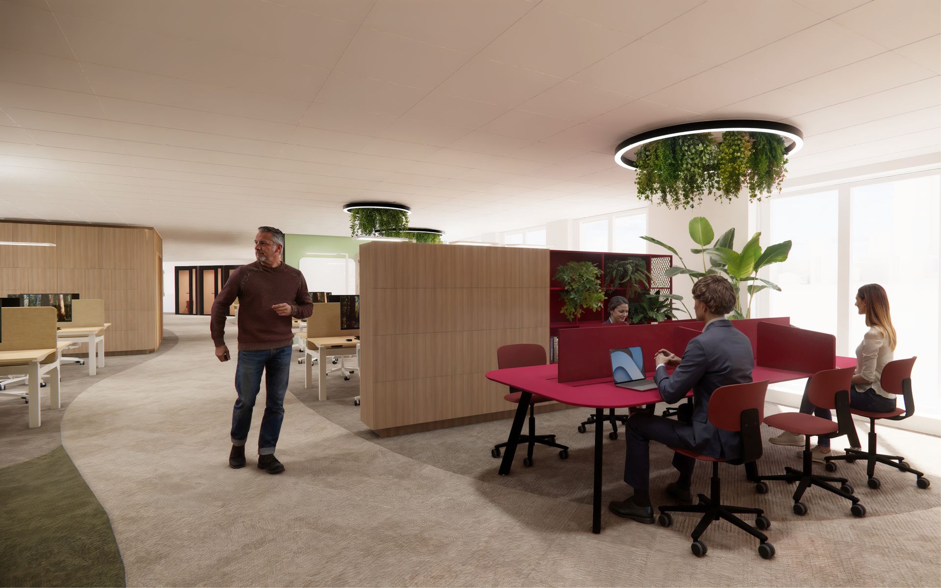 Modern open kantoor van Eneco Belgium met mensen die aan bureaus werken, rode stoelen en hangplanten.