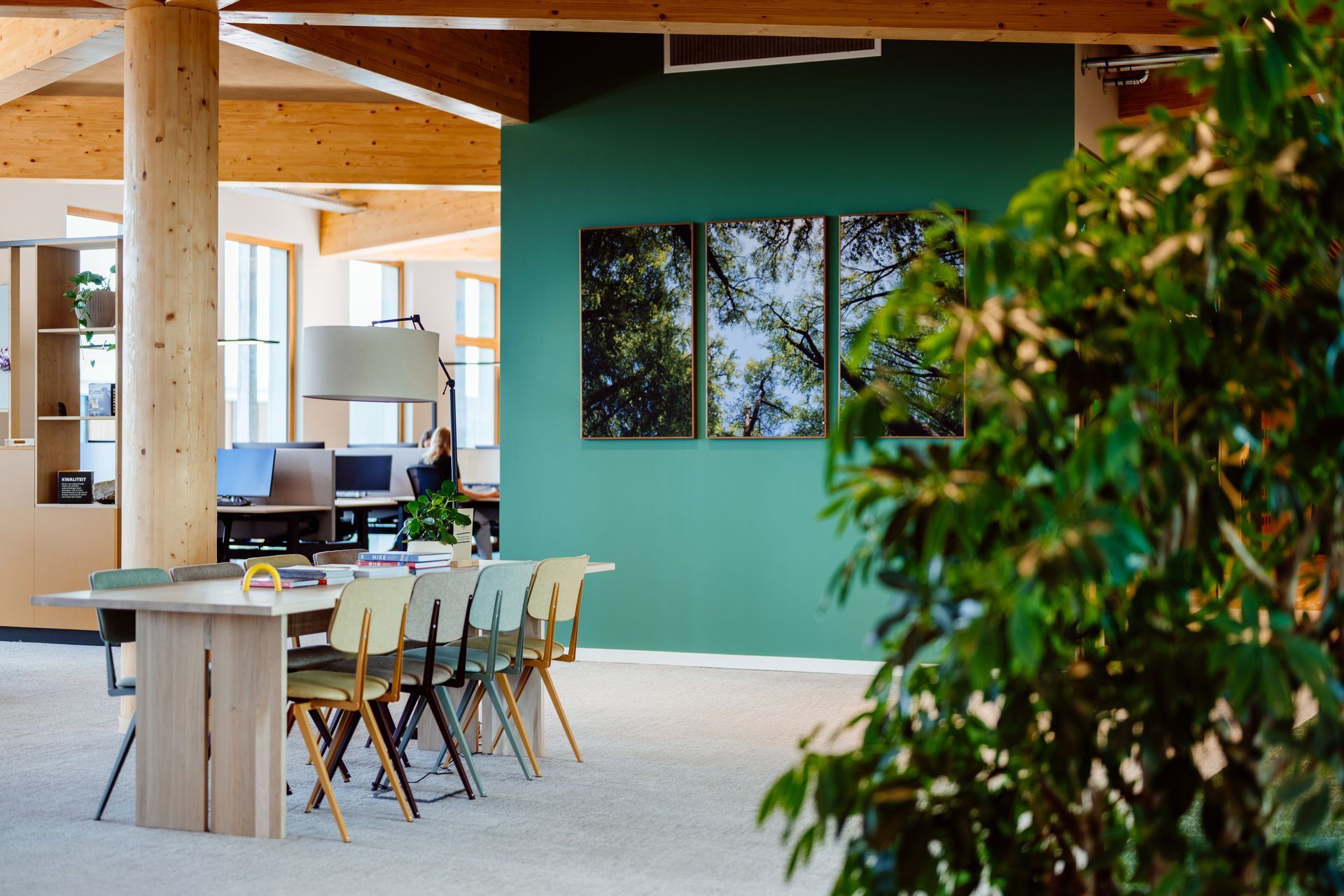 Een moderne entree kantoor Bever Interieurontwerp met lichte houten accenten, planten, grote bomen, een receptiebalie en een topografische Wandbetimmering Duurzaam, avontuurlijk hoofdkantoor in Pijnacker