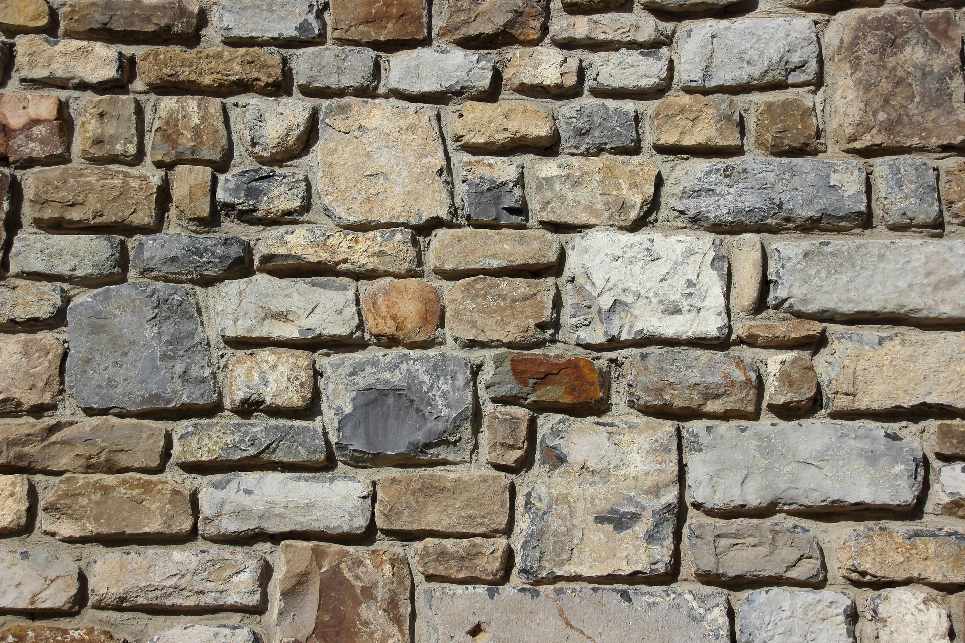 A close up of a brick wall made of different types of bricks